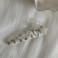Detail of elegant lace hair clip with artificial pearl bow on a white textured fabric - White Lace Pearl Bow BB Clip