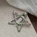Close-up of star-shaped silver metal hair clip with colorful enamel polka dots detail - Star Shape with Colorful Dots