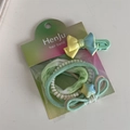 Close-up of mint green scrunchie set with star pendant and colorful hair accessories - Mint Green