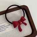 Detailed close-up of a high-elasticity red bow hair tie on a vintage display tray - Bowknot Hair Tie-Red