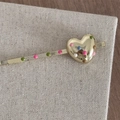 Close-up of golden metal hairpin with colorful polka dots and heart-shaped detail - Heart Shiny Gold Bobby Pin