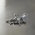 Detail of silver butterfly hair clip with liquid metal texture and opal stones - Bow