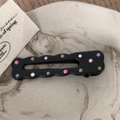 Detail of black resin hair clip with colorful polka dots on a marble tray - Black Drip Oil - Hollow Rectangle