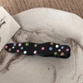 Close-up of black wavy metal hair clip with colorful polka dots on marble tray - Black Drip Oil - Solid Wave