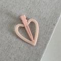 Detail of pink matte heart hair clip with hollow frame design on linen fabric - Light Orange