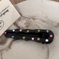 Detail of wavy black metal hair clip with colorful enamel polka dots on marble background - Black Drip Oil - Hollow Teardrop