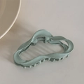 Detail view of light green wave-shaped hair claw clip with realistic stitching texture - Green (Dopamine Cloud)
