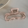 Close-up of matte nude pink hair claw clip with twisted wave edge and stitching details - Apricot (Dopamine Rectangle)