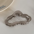 Macro shot of wavy khaki hair claw clip with stitch texture on white surface - Coffee (Dopamine Cloud)
