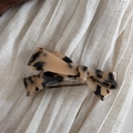 Close-up of tortoise shell bow hair clip featuring the gold France Handmade logo - Tortoiseshell