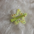 Detailed view of a star-shaped hair clip with colorful polka dots on lace background - Fruit Green