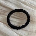Detailed view of thick braided black elastic hair tie with oval resin bead ornament - Black