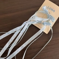 Detailed close-up of blue plaid bow hair clips with heart rhinestones and hanging tassels - Blue Gingham - Long Ribbon Bow