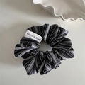 Detail of black and white striped scrunchie with woven texture and premium Korea label - Sea Salt Series Striped - Black