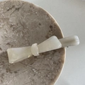 Close-up of cream white acetate bow hair clip with polished marble texture finish - Mermaid White Long Duckbill