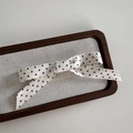 Detailed texture of ballet style polka dot bow hair clip on a minimalist display tray - Ballet Style Cream White Dot Duckbill Clip