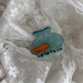 Detail der transparenten blauen Aquarium Haarklammer mit süßem orangefarbenem Fisch - Transparentes Fischglas - Blau