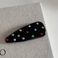 Dettaglio del fermaglio Y2K con strass colorati su una base nera lucida elegante - Nero Goccia