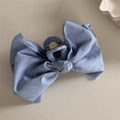 Macro view of light blue fabric bow hair claw clip with sturdy golden metal spring - Bow Claw Clip / Light Blue