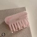 Close-up of pink marbled acetate hair claw clip with Barrette la France lettering - Pink Marble
