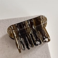 Detail of tortoiseshell acetate claw clip with gold Barrette La France text engraving - Coffee Marble