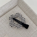 Detailed view of a sweet floral hair clip with black polka dots on a translucent finish - Clear Polka Dot - Seamless Flower