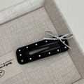 Detalle de una horquilla BB de cuero con lunares negros y un lazo de metal plateado - Negro Rectangular
