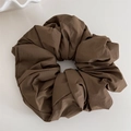 Detail view of large dark brown scrunchie with matte textured fabric and natural folds - Dark Coffee