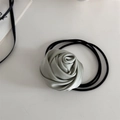 Detail of mint green satin rose hair scrunchie showing elegant petal textures and fabric - Mint Green Rose - Hair Tie