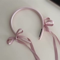 Detail of pink satin headband with elegant bow streamers and premium fabric texture - Bow Streamer Style / Pink