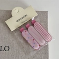 Detail of three pink patterned hair clips featuring rainbow dots, stripes, and checks - Bobby Pin / Pink