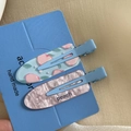 Detail of floral and marble acrylic hair clips with peach motif on a blue display card - Peach Soda