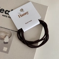 Detail of coffee brown multi-strand elastic hair tie on a white brand display card - Dark Coffee