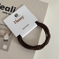 Detailed macro view of dark brown elastic hair ties on minimalist card display board - Dark Brown