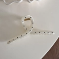 Detail of cream white polka dot hair claw clip with twisted design and gold spring - White Polka Dot - Hanger