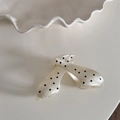 Detailed view of a cream claw clip with black polka dots and a glossy acetate finish - White Polka Dot - Hollow
