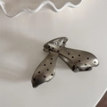 Detail view of a silver hair claw clip with black polka dots and subtle glitter finish - Coffee Polka Dot - Hollow