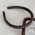 Close-up of wide-brimmed brown fabric headband with black polka dots in French style - Narrow Polka Dot / Dark Coffee