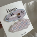 Detail of two cute cloud-shaped hair clips with polka dots and bow patterns on display card - Pink Plaid Bow (Pair)