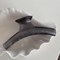 Detailed macro view of the translucent grey shark hair clip with sparkling silver glitter - Bar Style / Black