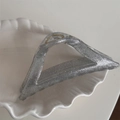 Close-up of a silver glitter hair claw clip with a stylish triangular cutout design - Triangle Style / Silver