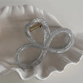 Close-up of a silver glitter hair claw clip on a white decorative shell tray - 8-Shape Style / Silver