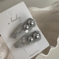 Close-up of two grey mesh hair clips with silver beads on a ceramic tray packaging - White Sequin Silver Bead - Teardrop Clip
