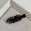 Nahaufnahme der Entenschnabel-Haarklammer mit schwarzem Spitzenmuster auf Rauchrosa-Acetat - Spurloser Clip - Schwarze Rose