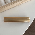 Close-up of amber acetate hair clip featuring gold FRANCE Handmade lettering details - Coffee Marbled