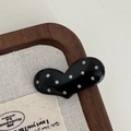 Close-up of a black heart-shaped hair clip with white polka dots on a wooden background - Heart Hair Clip Set / Black