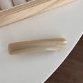 Detail of cream acetate spring clip hair accessory with golden France Handmade lettering - Apricot Marbled
