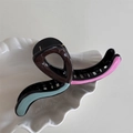 Close-up of a large wavy claw clip with colorful oil-drop design on a white tray - Multicolor Small Wave U-Shape Clip-Coffee