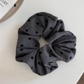 Close-up of dark grey heart-patterned scrunchie showing fabric texture and pleats - Grey Heart