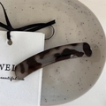 Macro detail of tortoiseshell acetate hair clip on an elegant minimalist display - Light Tortoise - Curved Clip
